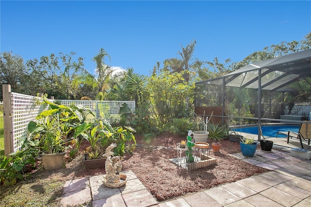 view of yard featuring a fenced in pool and a lanai