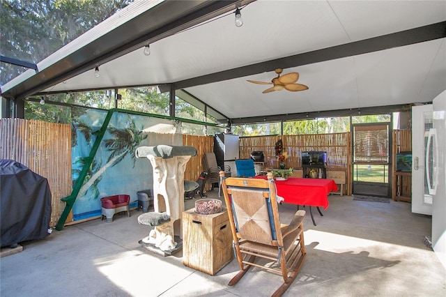 sunroom / solarium featuring ceiling fan and vaulted ceiling