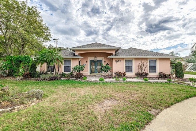 view of front of property featuring french doors and a front lawn