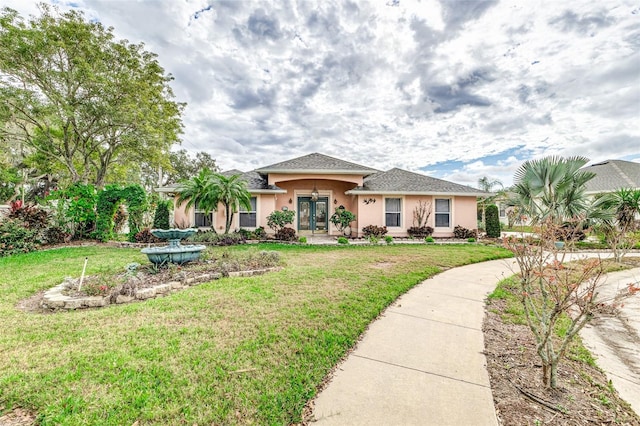 view of front of property featuring a front lawn and french doors