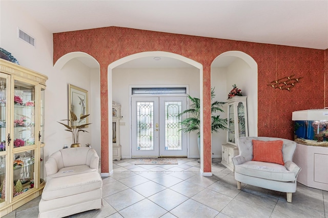 tiled foyer featuring french doors