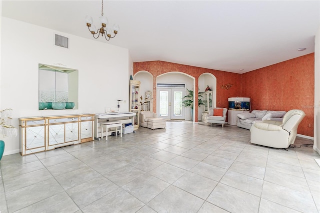 living room with french doors, light tile patterned floors, and a notable chandelier