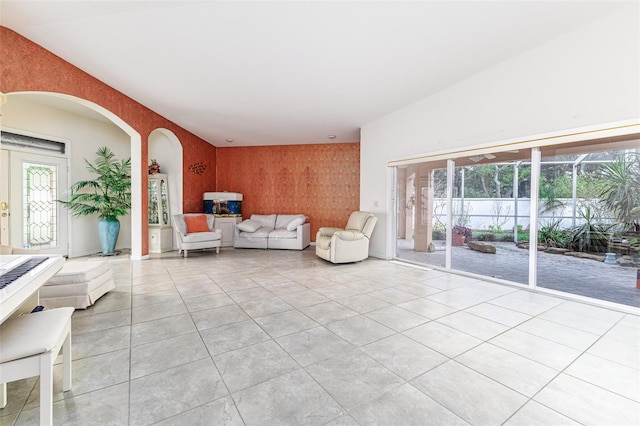 unfurnished living room with french doors and wood walls