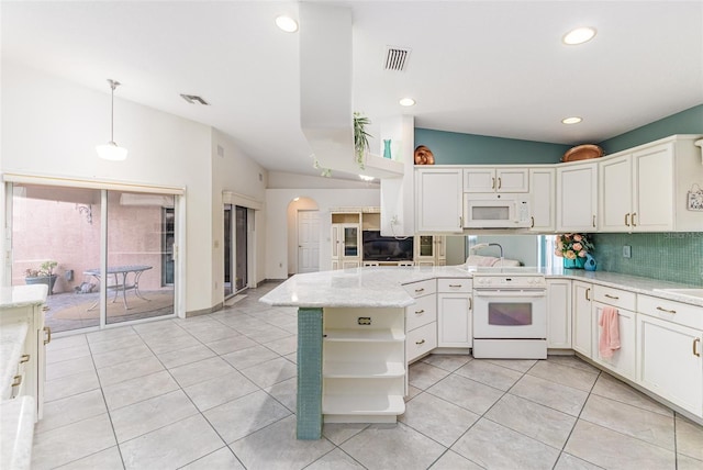 kitchen with kitchen peninsula, decorative backsplash, white appliances, hanging light fixtures, and lofted ceiling