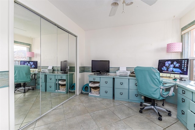 tiled office space featuring ceiling fan