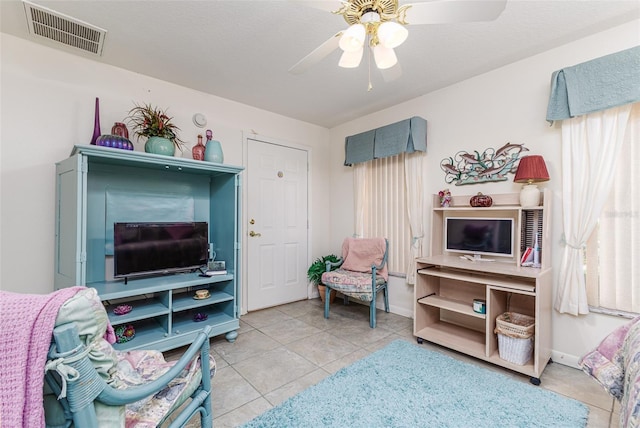 tiled living room featuring ceiling fan