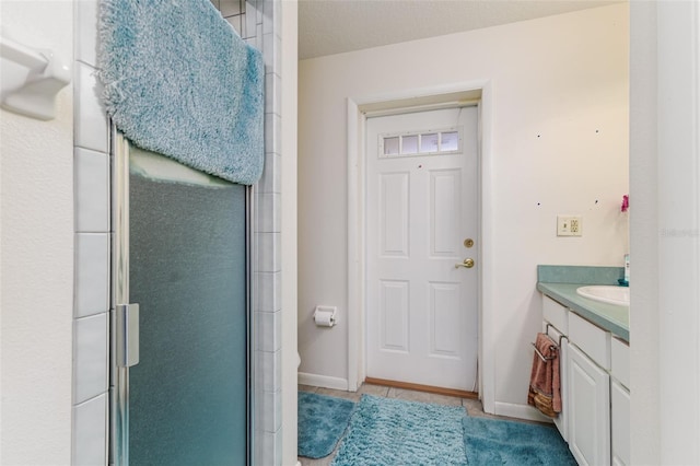 bathroom featuring vanity and a shower with shower door