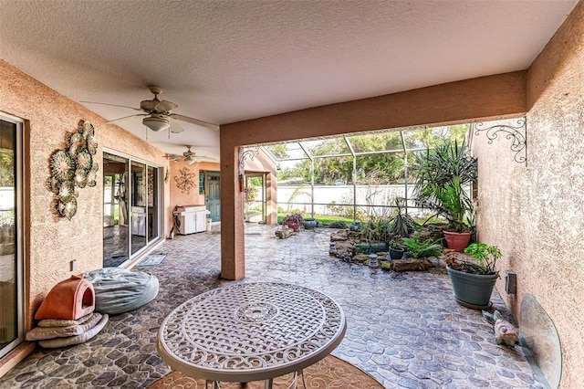 sunroom / solarium featuring ceiling fan