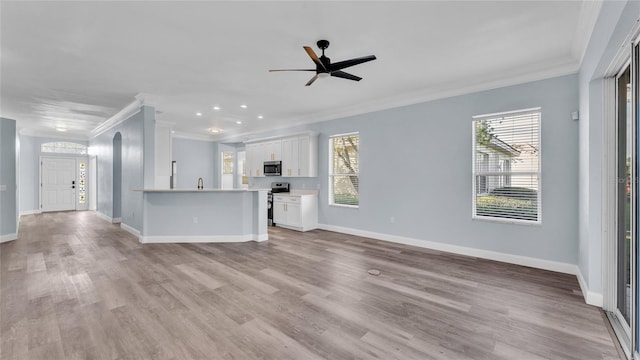 unfurnished living room with crown molding, sink, ceiling fan, and light hardwood / wood-style floors