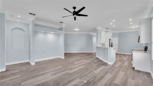 unfurnished living room featuring light hardwood / wood-style floors, ceiling fan, ornamental molding, and sink