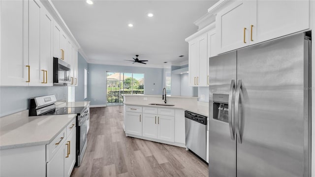 kitchen featuring white cabinetry, sink, ceiling fan, and stainless steel appliances