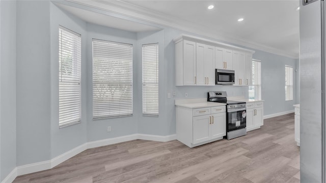 kitchen featuring white cabinets, stainless steel appliances, and a healthy amount of sunlight