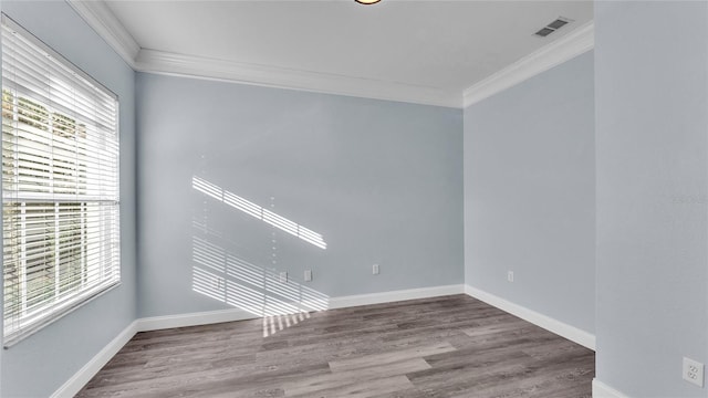 unfurnished room with hardwood / wood-style floors and crown molding