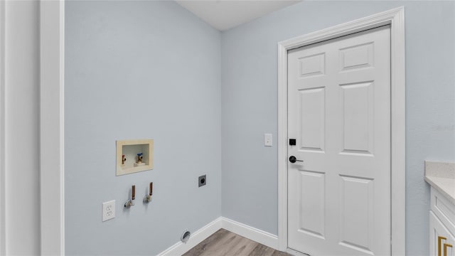 clothes washing area with electric dryer hookup, hookup for a gas dryer, washer hookup, and light wood-type flooring