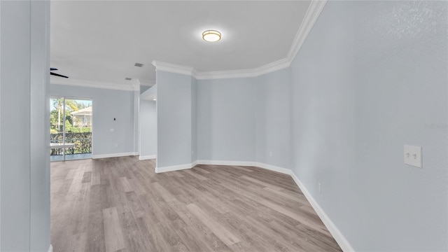 spare room with light hardwood / wood-style floors and crown molding