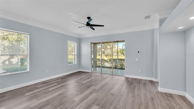 empty room featuring ceiling fan, light wood-type flooring, and ornamental molding