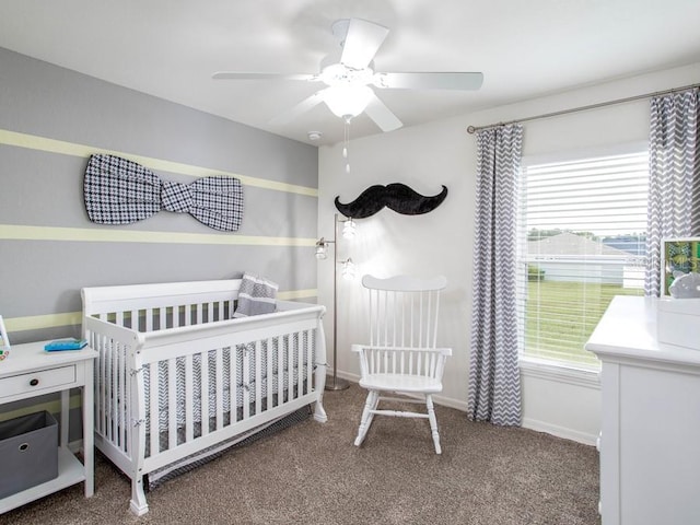 bedroom with a crib, carpet, and ceiling fan