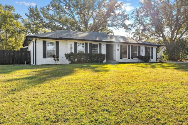 ranch-style home featuring a front yard