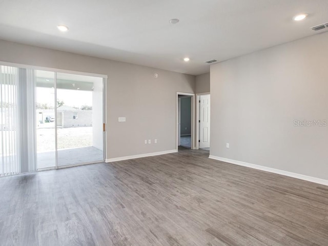 spare room with hardwood / wood-style floors