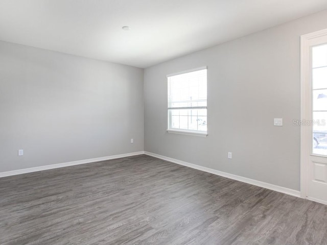 unfurnished room featuring dark wood-type flooring