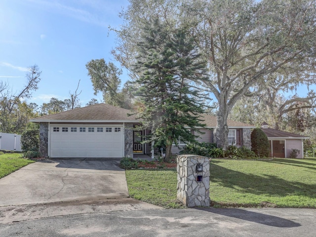 ranch-style house featuring a garage and a front lawn