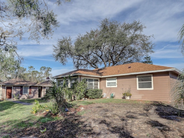 rear view of property with a yard