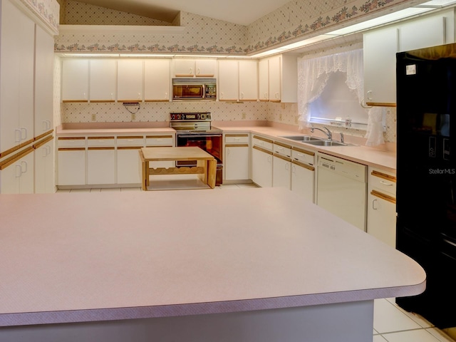 kitchen with black refrigerator, white dishwasher, sink, electric range, and white cabinets