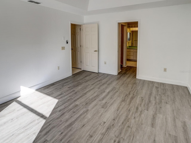 spare room with light hardwood / wood-style floors