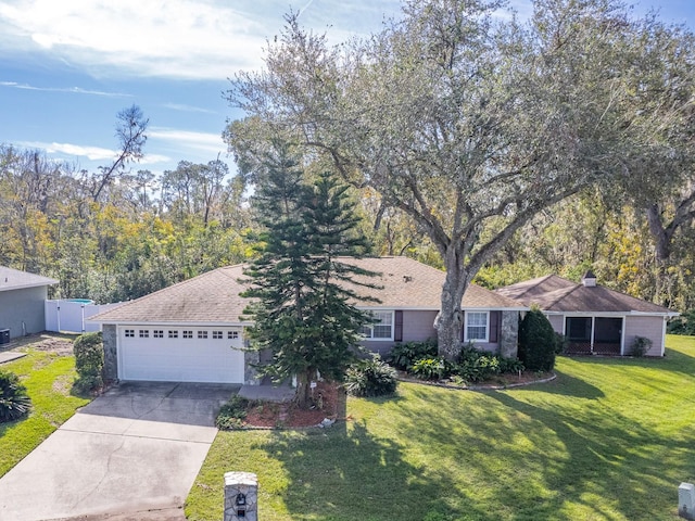 ranch-style home featuring a garage and a front lawn