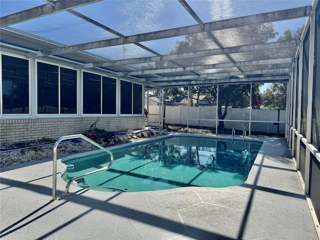 view of swimming pool featuring a fenced in pool, glass enclosure, a patio area, and fence