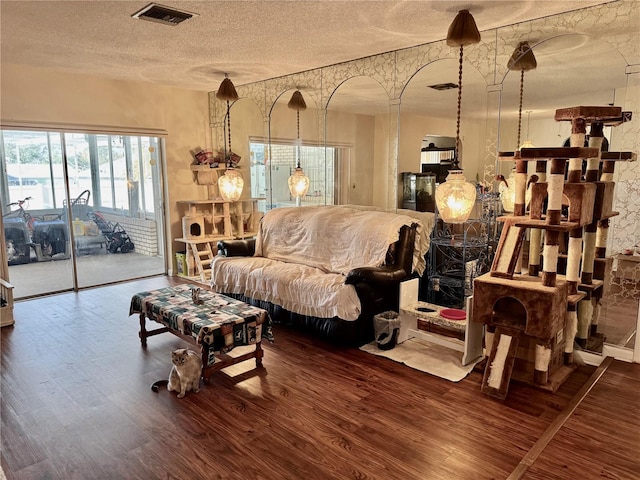 living room with wood-type flooring and a textured ceiling