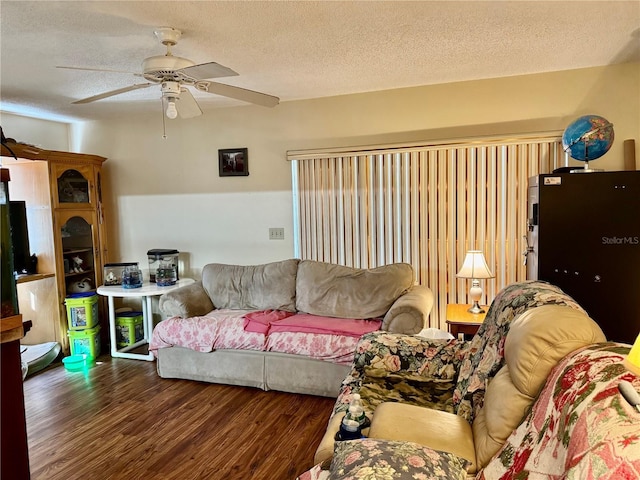 living room featuring a textured ceiling, a ceiling fan, and wood finished floors