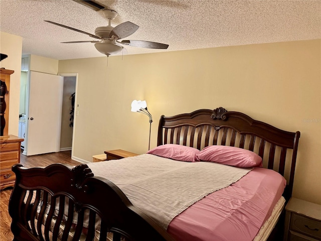 bedroom with ceiling fan, a textured ceiling, and wood finished floors