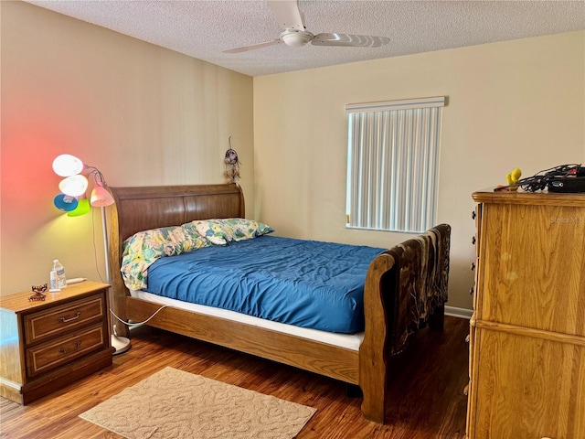 bedroom featuring a textured ceiling, ceiling fan, and wood finished floors