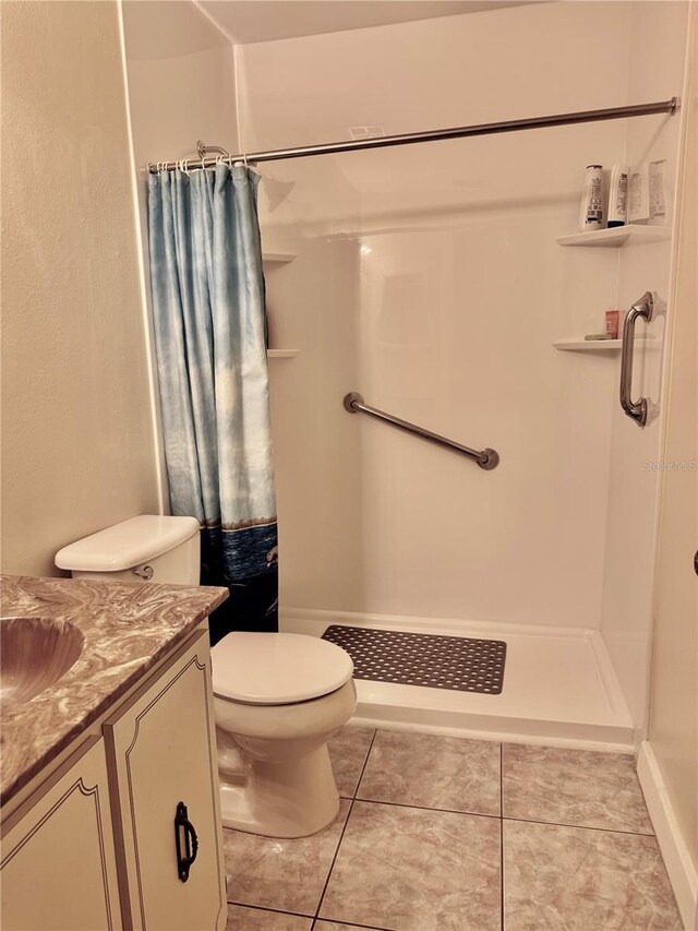 full bathroom with a stall shower, visible vents, toilet, tile patterned flooring, and vanity