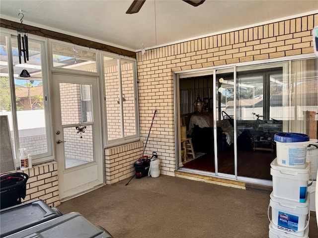 sunroom featuring ceiling fan