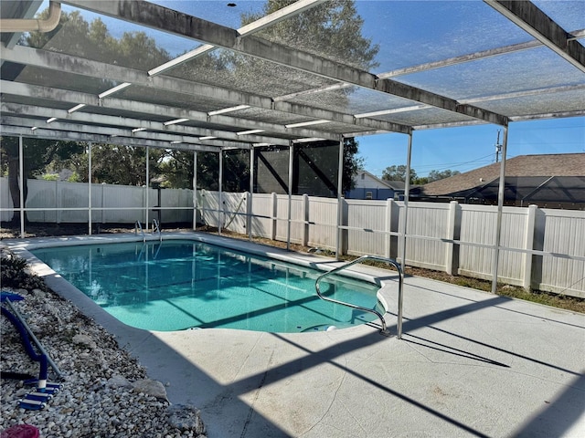 view of swimming pool with a lanai, a patio area, a fenced backyard, and a fenced in pool