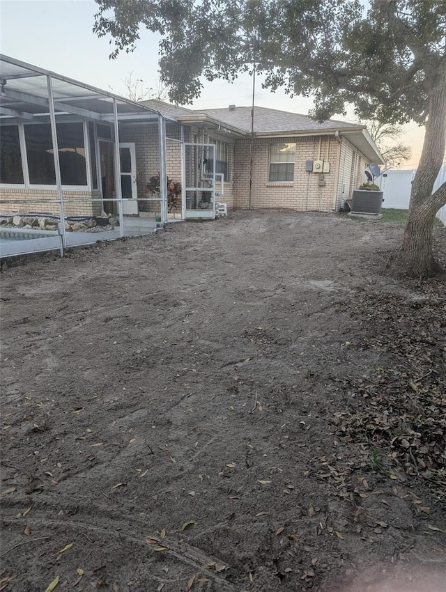 rear view of property with brick siding