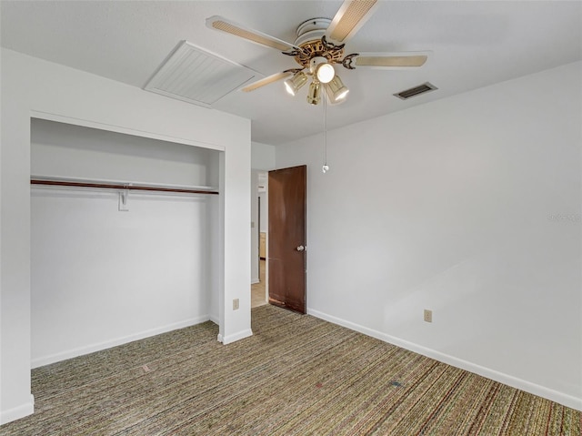 unfurnished bedroom with ceiling fan, a closet, and dark colored carpet