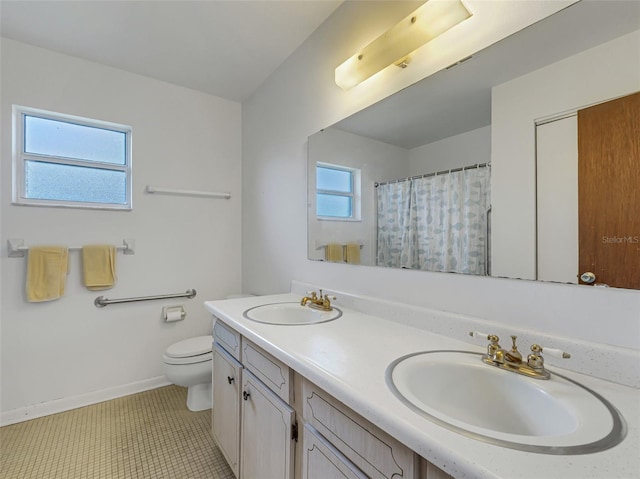 bathroom with tile patterned floors, vanity, and toilet