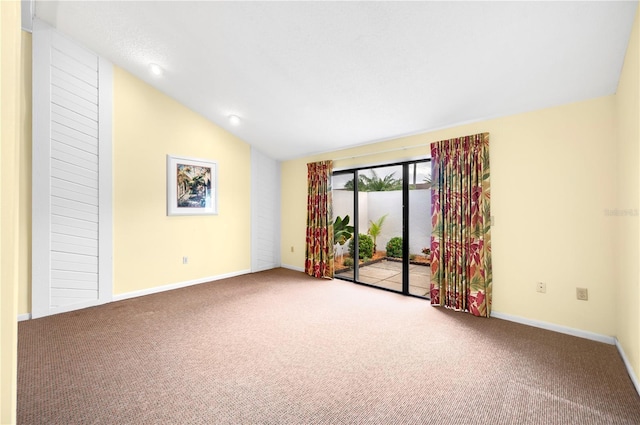 empty room featuring carpet floors and lofted ceiling