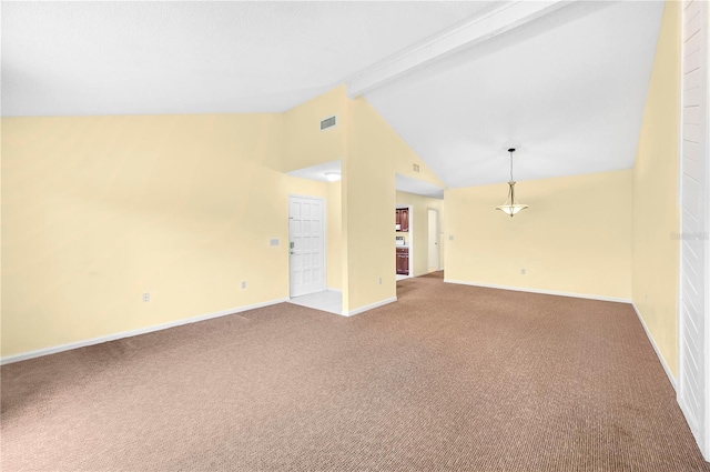 spare room featuring carpet flooring and lofted ceiling with beams