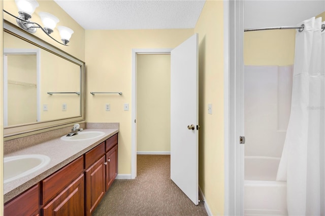 bathroom featuring shower / bath combination with curtain, vanity, and a textured ceiling