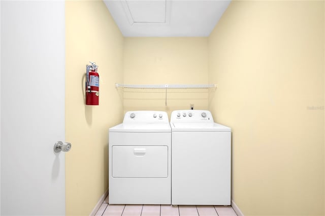 laundry room featuring washer and clothes dryer and light tile patterned flooring