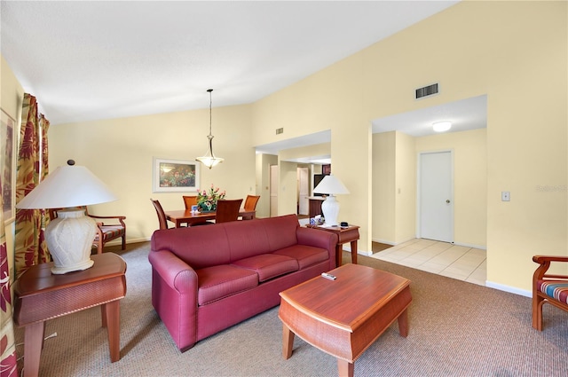 4241 Oak Loop Unit 36, Mulberry, FL 33860 - living room with light tile patterned floors and vaulted ceiling