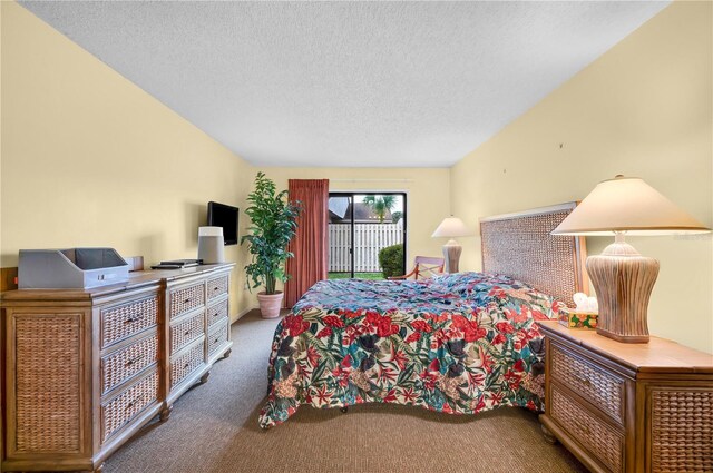 4241 Oak Loop Unit 36, Mulberry, FL 33860 - bedroom featuring access to exterior, a textured ceiling, and carpet floors