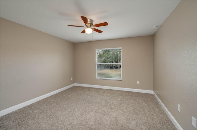 unfurnished room with ceiling fan and carpet floors