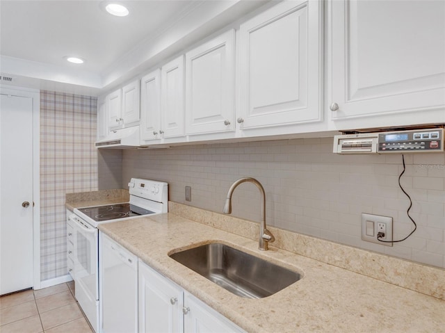 kitchen with white cabinetry, white appliances, sink, and light tile patterned floors