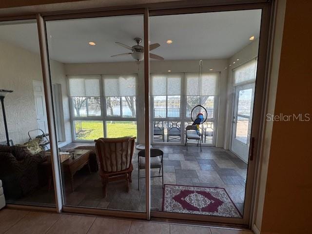 sunroom with ceiling fan and a healthy amount of sunlight