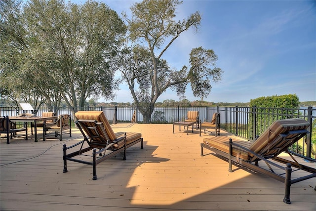 wooden terrace featuring a water view